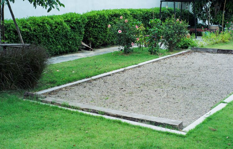 Landscape of grass field with petanque court in the garden of backyard